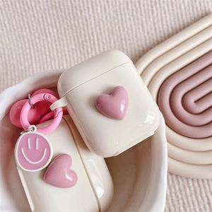 Minimalist cream white silicone AirPods case featuring 3D pink heart and smiley pendant