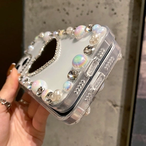Detailed view of pearl-embellished transparent folding phone case with rhinestone accents