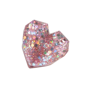 Pink heart-shaped telescopic phone grip with multi-faceted design and holographic sequins
