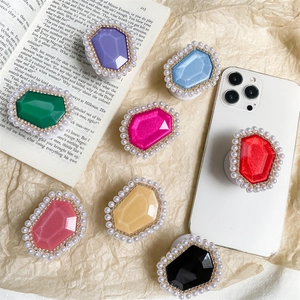 Collage of retractable phone grip sockets with faceted gemstone design and pearl borders