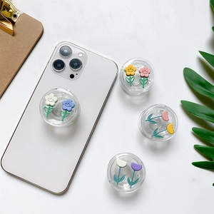 Detail of 3D resin tulip and daisy flowers on transparent expanding phone socket grip