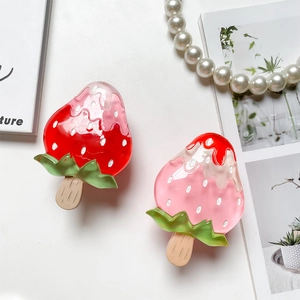 Detail shot of strawberry popsicle hair claw clip showing glossy acetate melting texture