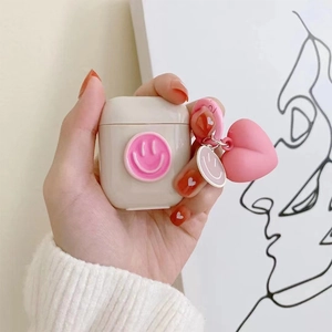Cute off-white AirPods case with pink smiley face and heart peach pendant charm