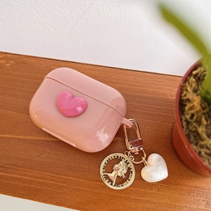Pink heart-shaped AirPods Pro case featuring gold Elizabeth II coin and pearl pendants
