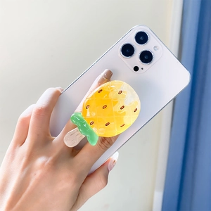 Macro detail of a 3D pineapple ice cream phone socket grip on a white smartphone