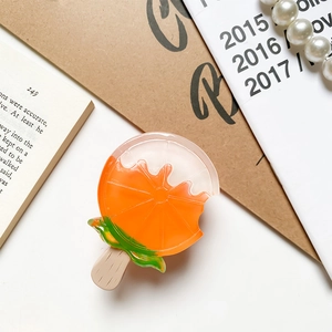 Detailed view of creative orange popsicle hair clip made of resin on a vintage background
