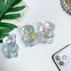 Detailed view of transparent 3D bear phone grips featuring colorful floral inner decorations
