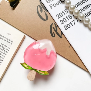 Close-up of pink ice cream phone grip accessory with melting cream and leaf detail