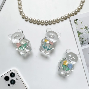 Close-up of three cute clear bear phone grips with colorful 3D resin flowers inside