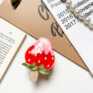 Close-up of a 3D strawberry ice cream phone grip with glossy resin finish and pearl accents
