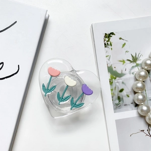 Detail of heart-shaped phone grip with 3D colorful tulips on a white background