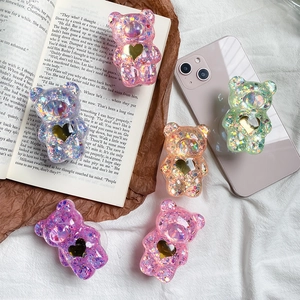 Dettaglio di supporti per telefono a orsetto 3D con glitter e cuore dorato in 5 colori