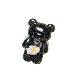 Sparkly black bear phone grip with astronaut and star 3D resin design on white base