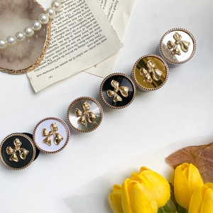 Detail of creative bowknot phone grips in black, white, gold, and silver finishes