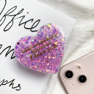 Detail of glittery heart phone grip with gold lettering and expandable stand