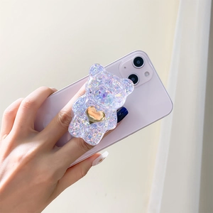 Supporto per telefono a forma di orso glitterato con cuore d'oro su smartphone viola