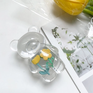 Detail of transparent bear hair claw clip with yellow flowers on lifestyle background