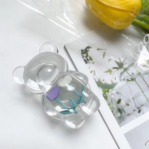 Detail of transparent bear phone grip with a purple tulip pattern in acrylic finish