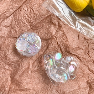 Detail of laser resin phone grips featuring 3D flowers, pearls and glitter butterflies