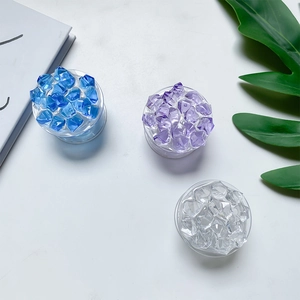 Close-up of three colorful ice-cube style resin collapsible phone grip holders