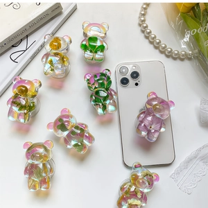 Iridescent bear phone grip holder with real dried flowers on white mobile device