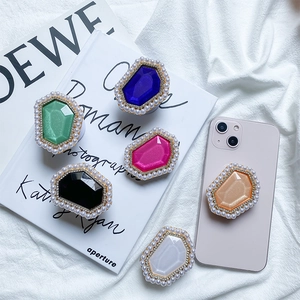 Close-up of gemstone-style phone sockets with faux pearls and rhinestones decoration