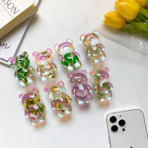 Macro view of 3D bear phone grips with colorful dried flowers and laser aurora coating