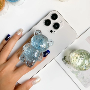 Blue glitter bear phone grip on white smartphone with transparent resin and silver flakes