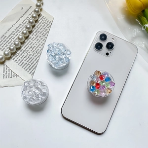 Detailed view of colorful crystal ice cube style folding phone socket grip holders