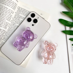 Detail of bear phone grip showing transparent resin with sparkling purple and pink foil