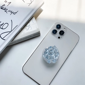Blue ice crystal resin retractable phone grip socket mounted on a white smartphone