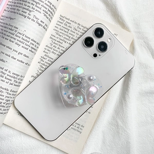 Macro shot of a heart-shaped laser butterfly phone grip with pearls and glitter