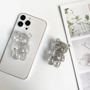 Macro detail of transparent bear phone socket with sparkling silver foil flakes inlay