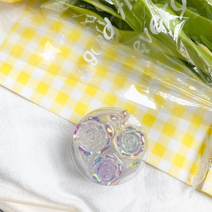 Detail of round laser flower phone grip with iridescent rose and butterfly design