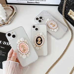 Detail of iPhone case with vintage camellia cameo portrait and pearl floral decorations