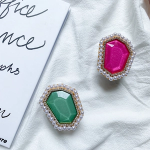 Close-up of luxury foldable phone grips with vibrant gems, rhinestones and pearls