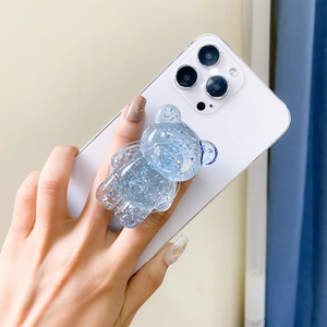 Detail of light blue transparent resin bear phone grip with silver glitter and sequins