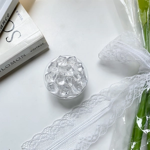 Detailed top view of a round collapsible phone grip with clear crystal ice decorations