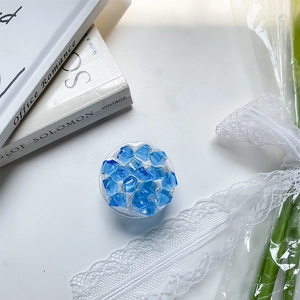 Close-up of a blue crystal ice resin phone grip on a vintage aesthetic background