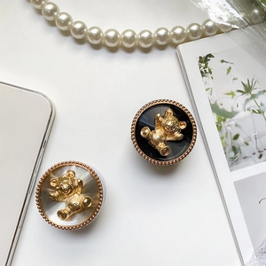 Detail of bear phone grip set in black and silver finishes with luxury pearl accessories