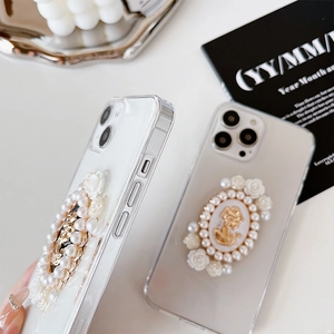 Detail of luxury iPhone case with pearl floral embellishments and vintage cameo relief