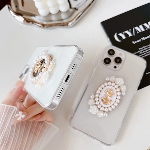 Detailed view of luxury iPhone case with vintage cameo relief and pearl embellishments