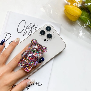 Detail of glitter resin bear phone socket stand showing secure grip and sparkling sequins