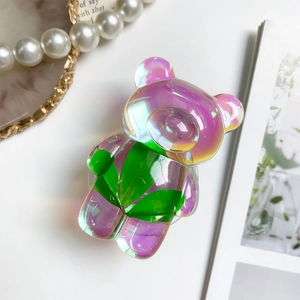 Close-up of 3D bear phone grip with iridescent laser finish and green leaf pattern