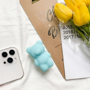 Collapsible light blue 3D bear cell phone grip holder with a matte silicone finish