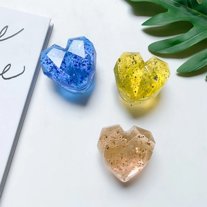 Detail of faceted heart-shaped phone grips with gold foil in blue, yellow and champagne