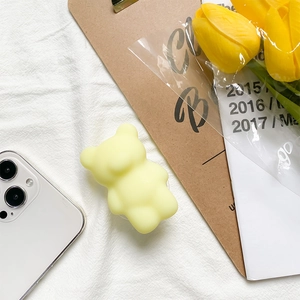 Cute pale yellow gummy bear cell phone socket grip with retractable airbag stand
