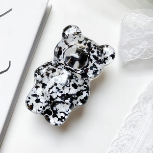 Macro shot of 3D bear phone grip with black and white glitter in clear resin finish