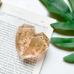 Detail of heart-shaped phone grip with champagne resin, gold foil, and silver flakes