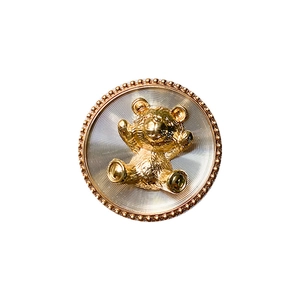 Golden bear motif phone stand with metallic concentric texture and beaded edge design